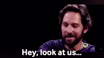 Paul Rudd smiling and gesturing while saying, "Hey, look at us..." suggesting surprise or pride in how well things have turned out.