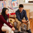 Man talking to a teacher doing a background check for childcare services