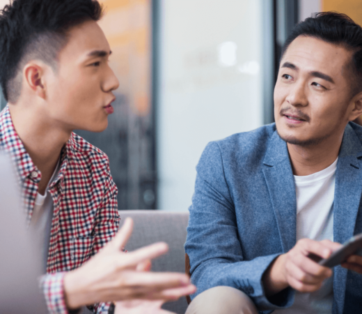 two male colleagues having a chat in the office