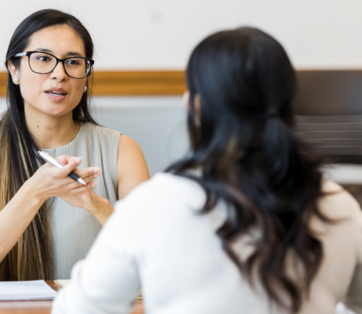 woman talking to her colleague in the office
