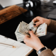 a woman handling money - federal budget