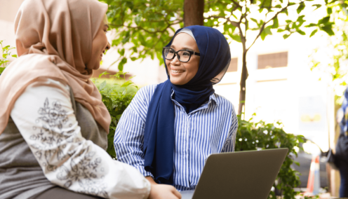 two malay women chatting happily to each other