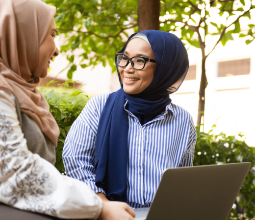 two malay women chatting happily to each other