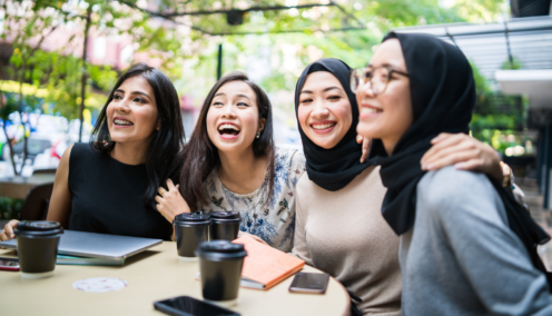 group of colleagues chatting and laughing together