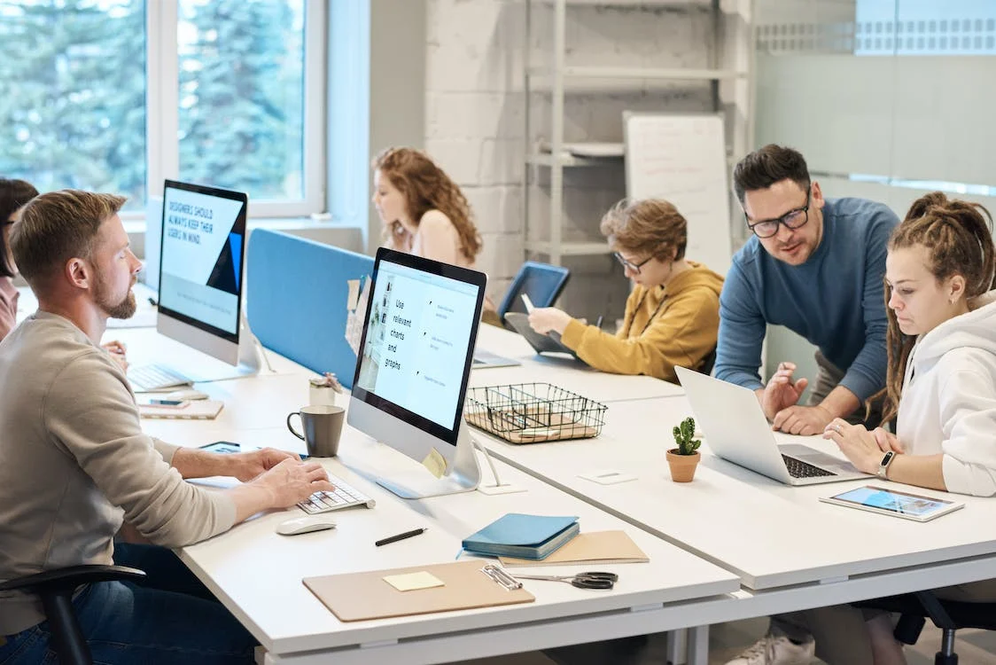 office scene with everyone at their desks hard at work