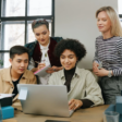group of diverse employees sitting around the table discussing