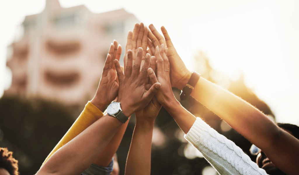 a group of people high fiving each other